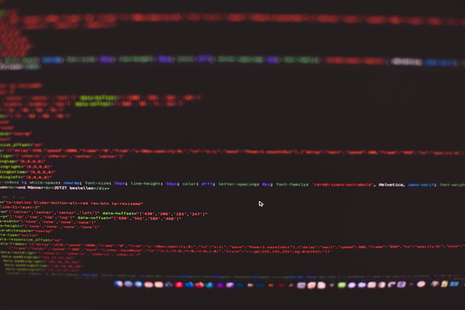 A close-up view of a laptop screen displaying lines of colorful code on a dark background, situated on a wooden table, with a creamy-colored coffee mug placed next to it. The mug features printed text