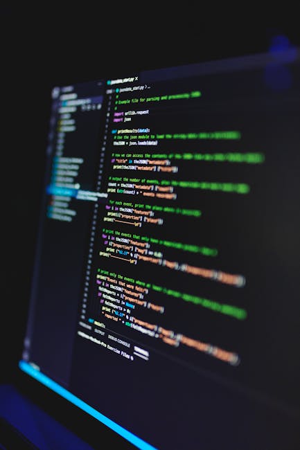 A computer screen displaying lines of programming code with various colors indicating syntax elements. The code appears in a dark-themed text editor, with the lines slightly blurred and illuminated by